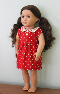 18" doll wearing red and white polka dotted dress featured in the Make a Friend Doll's Wardrobe Sewing Pattern by Jennifer Jangles