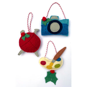 Camera, knitting needles & yarn, paint palette ornaments included in the Hobby & Craft Felt Holiday Ornaments Sewing Pattern