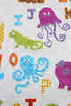 Close up of the appliquéd jellyfish, iguana, and octopus featured on the ABC Animals Applique Quilt Paper Sewing Pattern by Jennifer Jangles