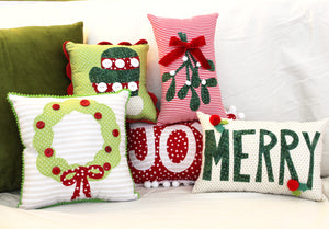 Wreath, mistletoe, mitten, Merry, Joy appliquéd pillows featured in the Mini Holiday Pillows Sewing Pattern