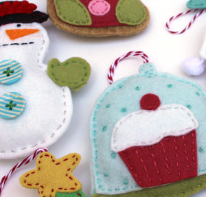 Close up of a felt cupcake ornament featured in the Bakeshop Felt Holiday Ornaments Sewing Pattern by Jennifer Jangles